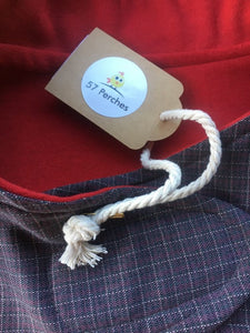 wool blend dog coat; grey check outer with red wool flannel lining, available in 5 sizes to suit all dogs. Flay lay photo showing close up of both fabrics used and the swing tag