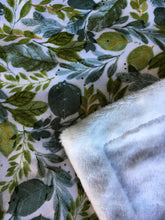 Load image into Gallery viewer, Dolls minky blanket cotton front synthetic minky back green leafy foliage print close up of fabric showing folded minky corner