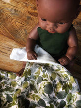 Load image into Gallery viewer, Dolls minky blanket cotton front synthetic minky back green leafy foliage print indigenous doll sitting with blanket over lap