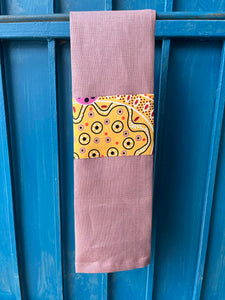 A rose pink tea towel made from European linen and featuring the art work Summertime Rainforest by Indigenous artist Heather Kennedy.