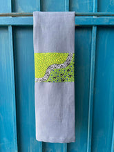 Load image into Gallery viewer, A blue tea towel made from European linen and featuring the art work Goanna Dreaming by Australian Indigenous artist Heather Kennedy. The tea towel is hanging on a deep blue coloured wall.
