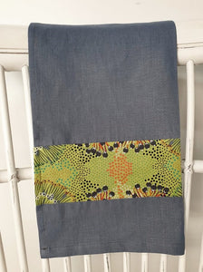 Linen tea towel, indigenous design tea towel, Australian Aboriginal artist, Bush Plum by Polly Wheeler. A splash of bright green print on denim blue linen
