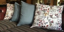Load image into Gallery viewer, Denim blue linen cushions with a vibrant berry trim and berry print cushions with a contrasting blue linen button trim. 
