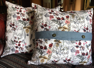 Denim blue linen cushions with a vibrant berry trim and berry print cushions with a contrasting blue linen button trim. 