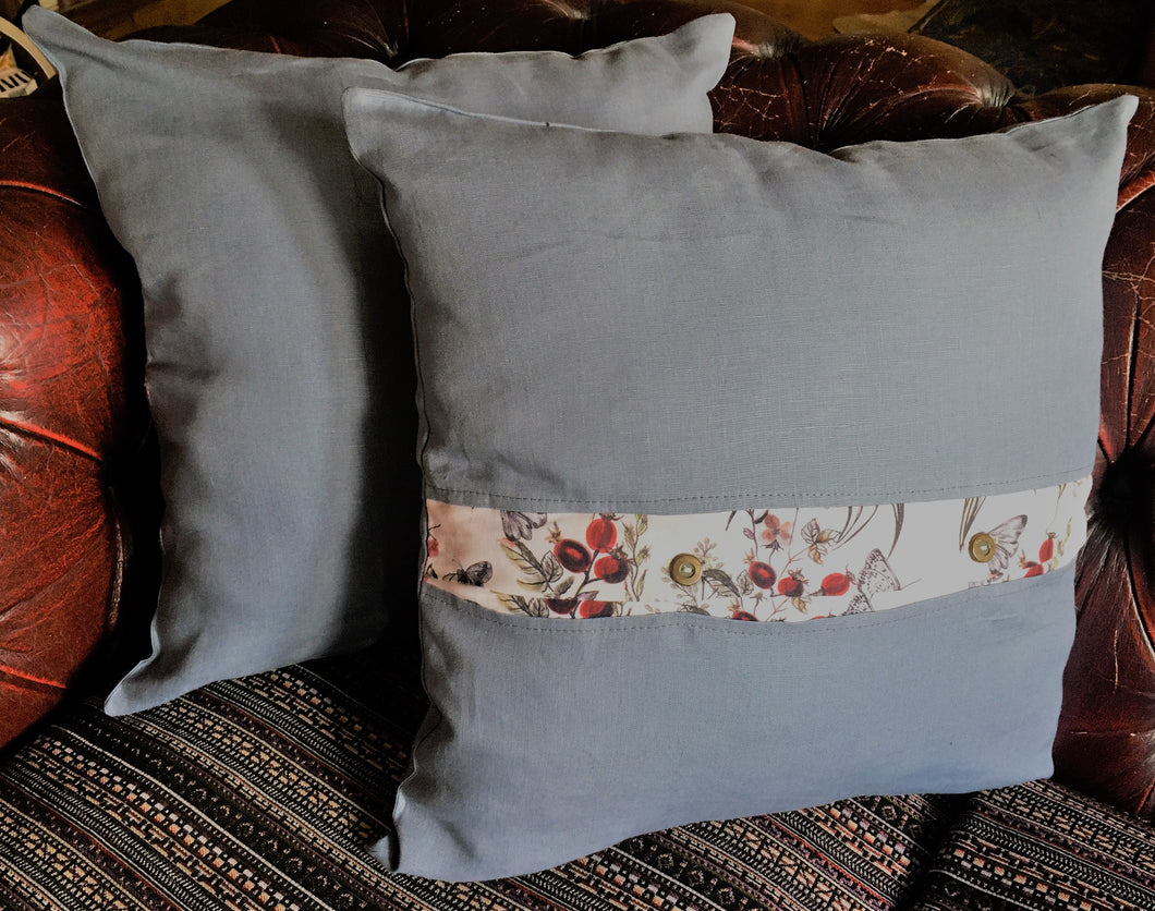 Denim blue linen cushions with a vibrant berry trim and berry print cushions with a contrasting blue linen button trim. 