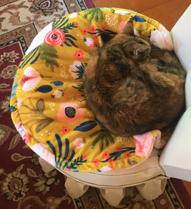 Kitty, the tortoise shell is sleeping soundly on her cosy minky cat mat.