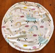 Load image into Gallery viewer, a round cat mat made with 3 layers of minky. Featuring a cute design of rainbows and llama like unicorns in soft baby blues, pinks and yellows