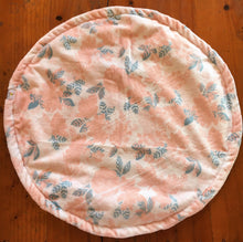 Load image into Gallery viewer, a round cat mat made with 3 layers of minky. Featuring a floral design in a pale pink with blue, grey leaves on a pale cream background