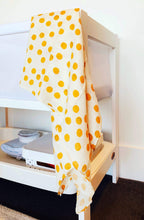 Load image into Gallery viewer, double muslin baby wrap featuring smiley faces in yellow. Decorate your nursery and nest for baby. Gifts.